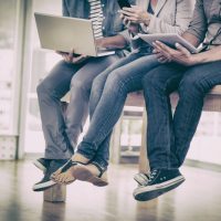 Three creative business team working on electronic devices